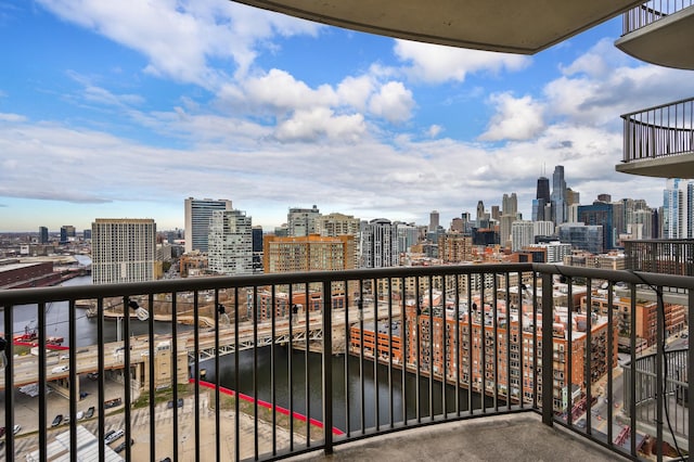 balcony with a view of city and a water view