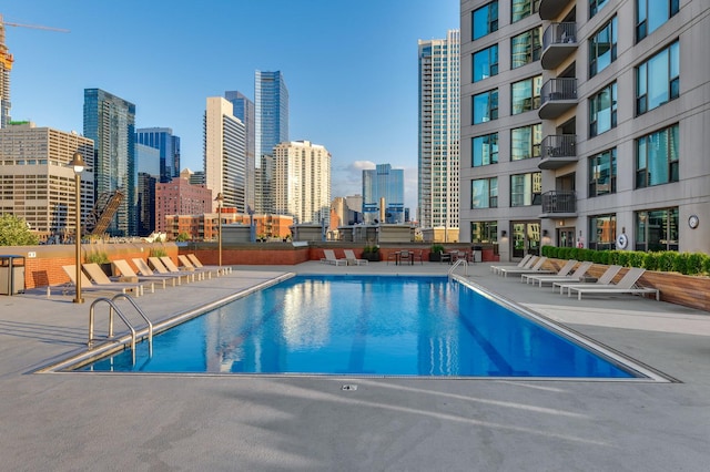 pool with a view of city and a patio