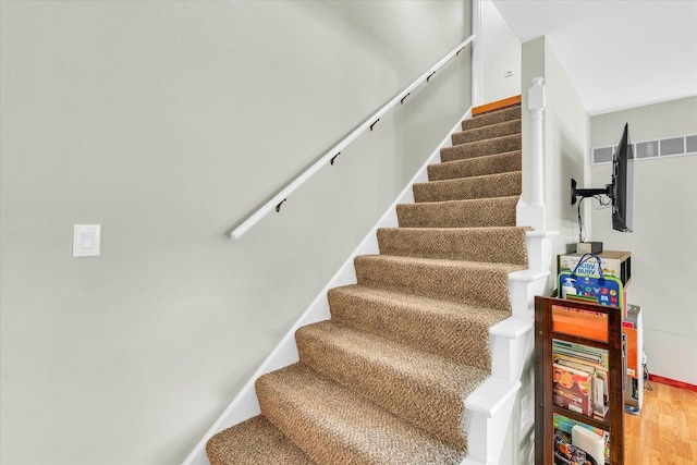 staircase with wood finished floors