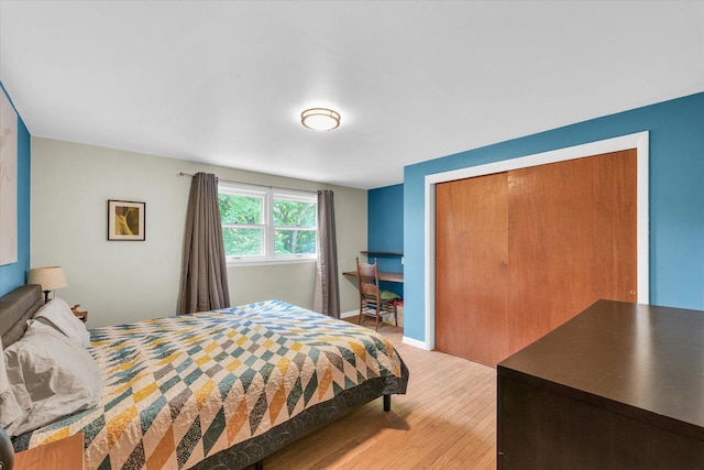 bedroom featuring light wood-style floors and a closet