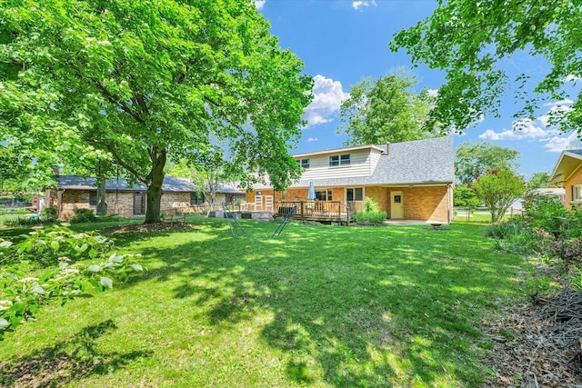 back of house with brick siding and a deck