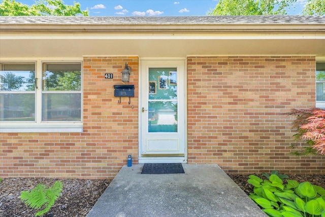property entrance featuring brick siding