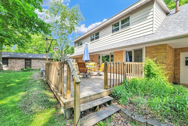 deck with a lawn and outdoor dining space