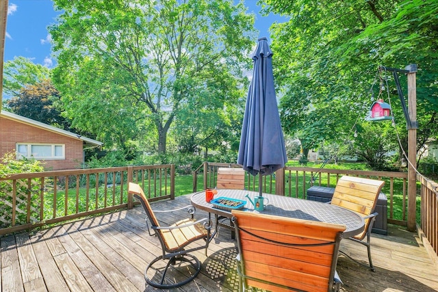 wooden deck featuring outdoor dining area