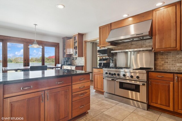 22846 W Lochanora Dr, Hawthorn Woods, IL 60047 - kitchen with appliances with stainless steel finishes, wall chimney range hood, light tile patterned floors, tasteful backsplash, and glass insert cabinets