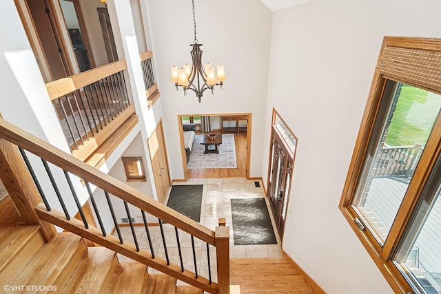 22846 W Lochanora Dr, Hawthorn Woods, IL 60047 - foyer with a chandelier, wood finished floors, a towering ceiling, stairway, and baseboards