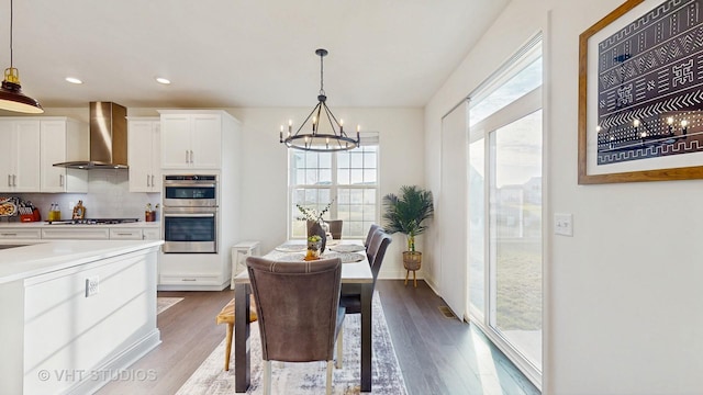 dining room with a chandelier, recessed lighting, dark wood-style flooring, and a healthy amount of sunlight