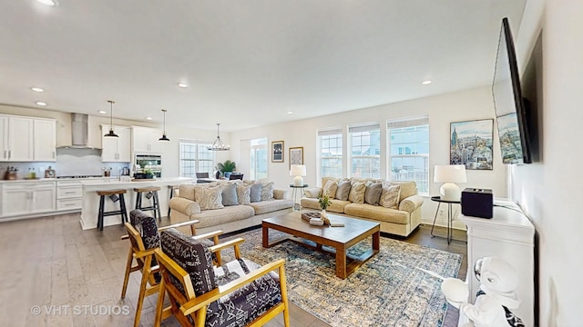 living area with wood finished floors and recessed lighting