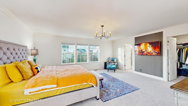bedroom with a chandelier, a closet, a walk in closet, and carpet floors