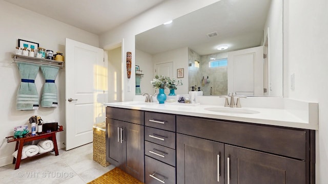 bathroom with a sink, visible vents, a shower stall, and double vanity