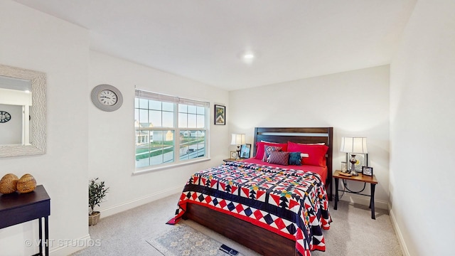 carpeted bedroom featuring baseboards