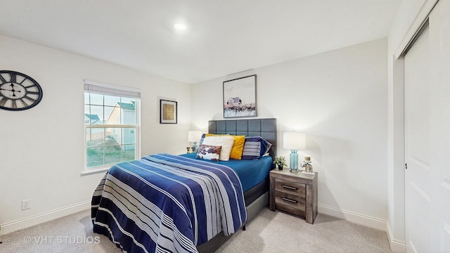 bedroom featuring a closet, carpet flooring, and baseboards