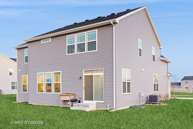 rear view of house with a patio area, central AC, and a lawn