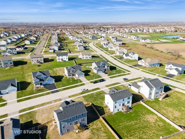drone / aerial view featuring a residential view and a water view