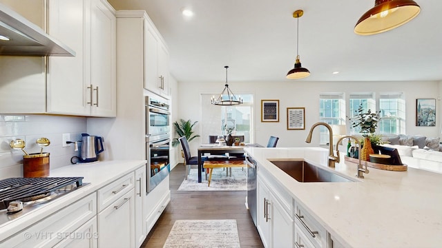 kitchen with recessed lighting, dark wood-style floors, white cabinets, a sink, and ventilation hood