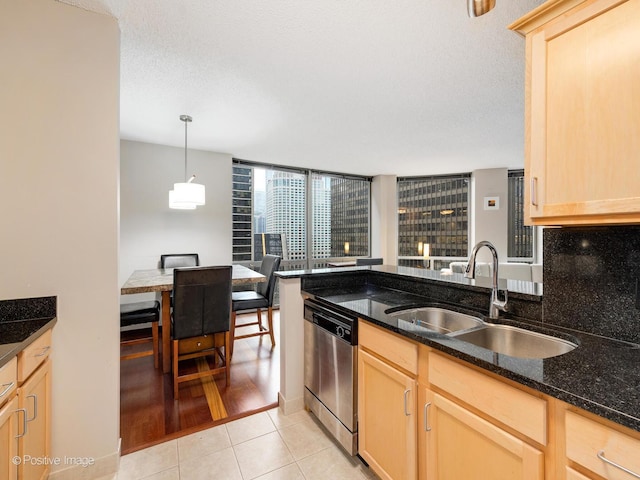 222 N Columbus Dr Unit 809, Chicago, IL 60601 - kitchen with dark stone counters, a sink, light tile patterned floors, light brown cabinetry, and dishwasher