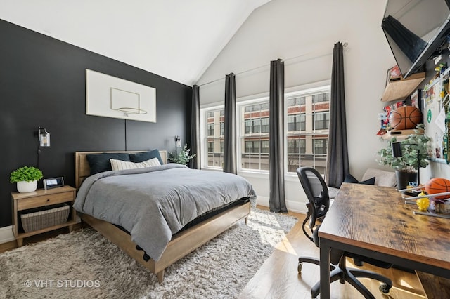 2733 N Maplewood Ave, Chicago, IL 60647 - bedroom with lofted ceiling, baseboards, and wood finished floors