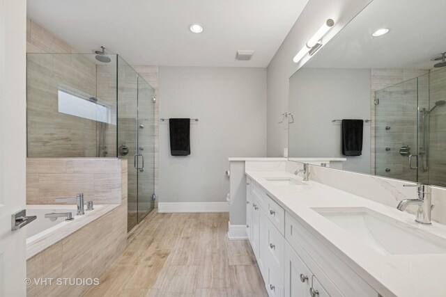 2733 N Maplewood Ave, Chicago, IL 60647 - bathroom featuring a garden tub, baseboards, a sink, and a stall shower