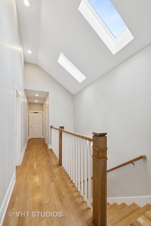 2733 N Maplewood Ave, Chicago, IL 60647 - hallway with light wood-type flooring, baseboards, recessed lighting, and vaulted ceiling with skylight