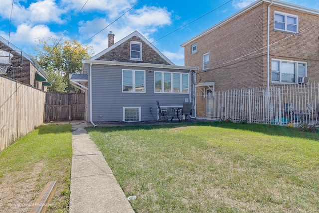 2434 W 47th Pl, Chicago, IL 60632 - back of property featuring a yard, a patio area, fence, and a chimney