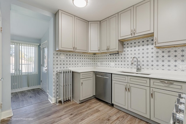 2434 W 47th Pl, Chicago, IL 60632 - kitchen featuring a sink, light countertops, radiator heating unit, light wood finished floors, and stainless steel dishwasher