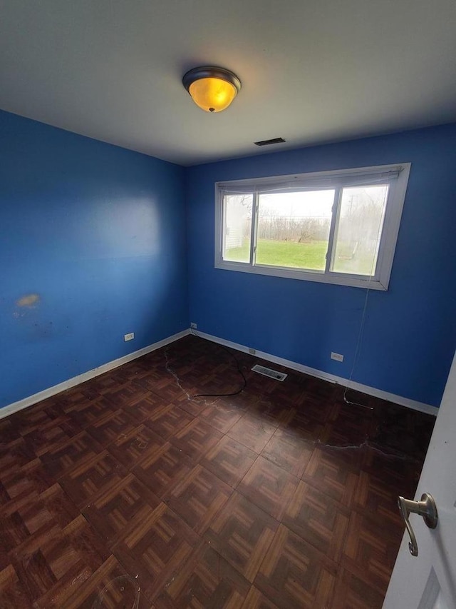 empty room featuring visible vents and baseboards