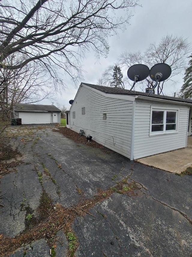 view of side of property with an outbuilding