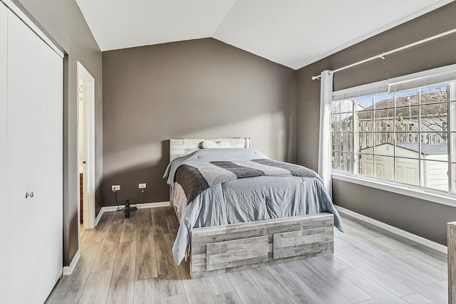 1412 Plantain Dr, Minooka, IL 60447 - bedroom featuring lofted ceiling, baseboards, and wood finished floors