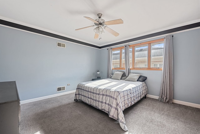 carpeted bedroom featuring visible vents, baseboards, and ornamental molding