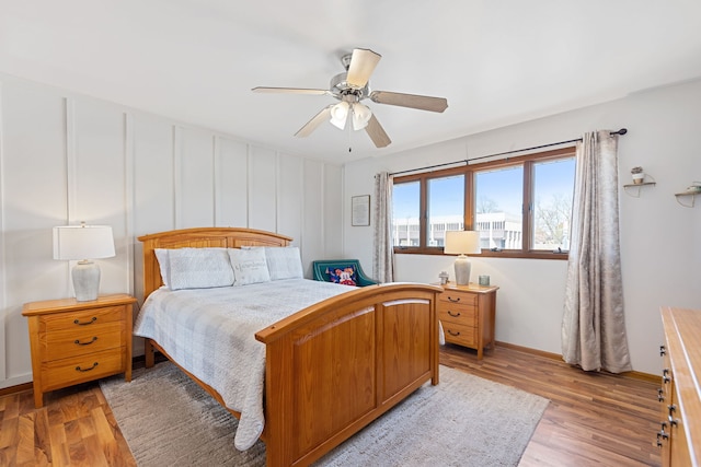 bedroom featuring baseboards, a ceiling fan, and light wood-type flooring