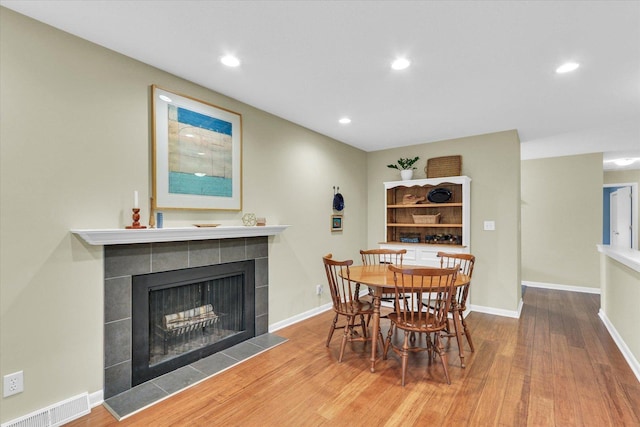 1104 Parkview Dr, Mahomet, IL 61853 - dining area with a tile fireplace, wood finished floors, and recessed lighting