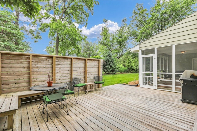 1104 Parkview Dr, Mahomet, IL 61853 - deck featuring a sunroom, a grill, outdoor dining area, and a lawn