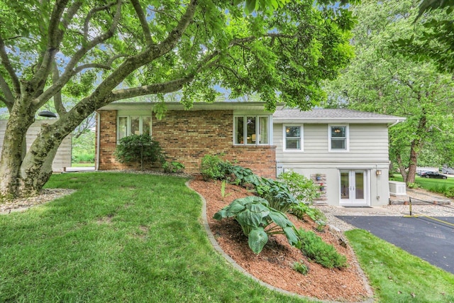 1104 Parkview Dr, Mahomet, IL 61853 - view of front of home with french doors, a front lawn, and brick siding