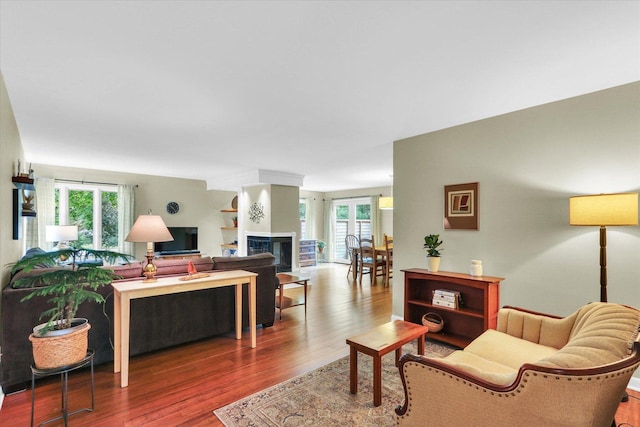 1104 Parkview Dr, Mahomet, IL 61853 - living room with healthy amount of natural light, wood finished floors, and a glass covered fireplace