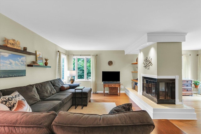 1104 Parkview Dr, Mahomet, IL 61853 - living room featuring wood finished floors and a multi sided fireplace