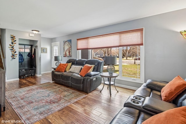 living area featuring baseboards and hardwood / wood-style floors