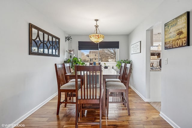 dining room featuring baseboards and wood finished floors
