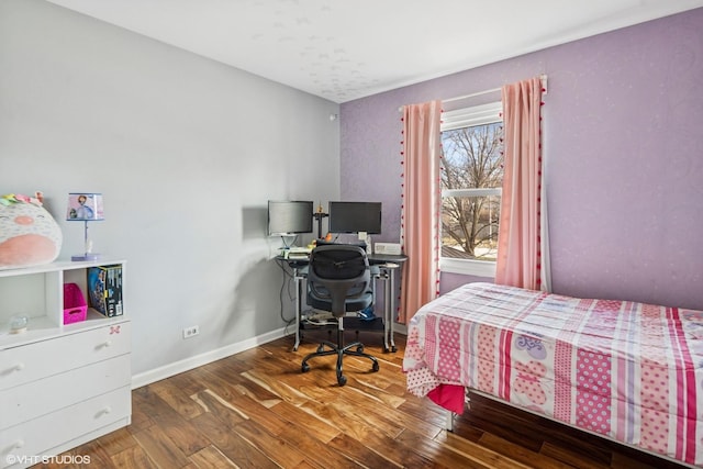 bedroom with wood finished floors and baseboards