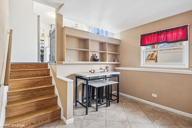 interior space featuring baseboards and stairway