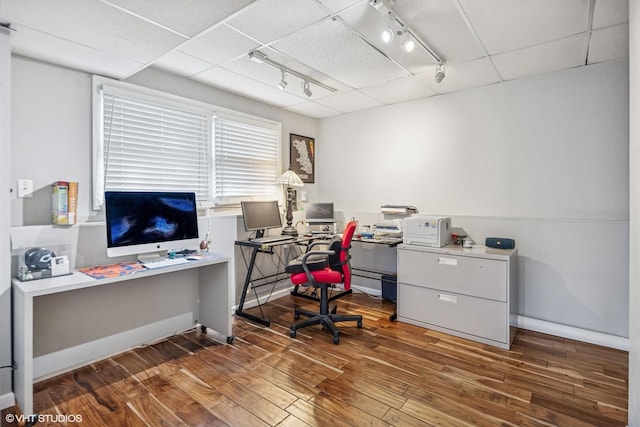 office featuring track lighting, baseboards, and wood finished floors