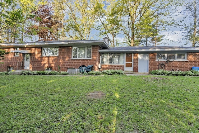 14750 W Hickory Ave, Lemont, IL 60439 - tri-level home featuring brick siding, a front yard, and a chimney