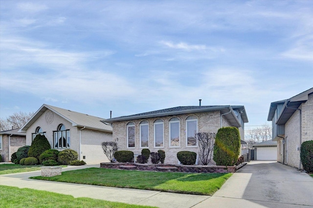 view of front facade featuring an outbuilding, brick siding, and a front yard