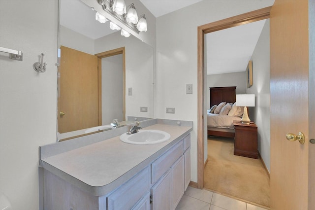 bathroom with tile patterned floors, ensuite bath, and vanity