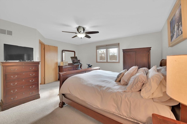 bedroom with carpet, visible vents, and ceiling fan