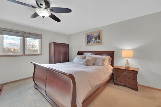 bedroom featuring ceiling fan, light carpet, and baseboards