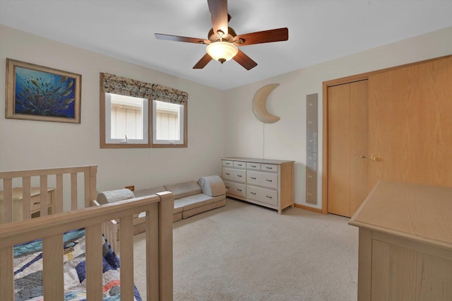 bedroom featuring a ceiling fan and light colored carpet