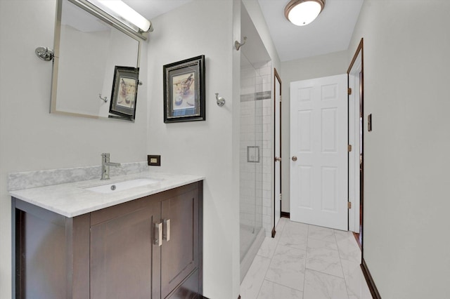 bathroom with baseboards, vanity, marble finish floor, and a stall shower