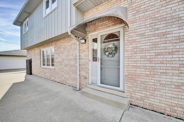 entrance to property with brick siding and board and batten siding