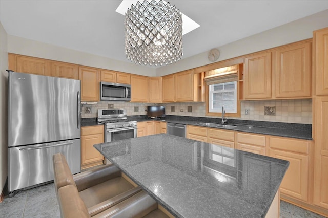 kitchen with tasteful backsplash, light brown cabinetry, appliances with stainless steel finishes, and a sink
