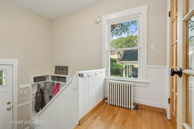 406 S Evergreen Ave, Arlington Heights, IL 60005 - laundry room featuring radiator, healthy amount of natural light, light wood finished floors, and a wainscoted wall